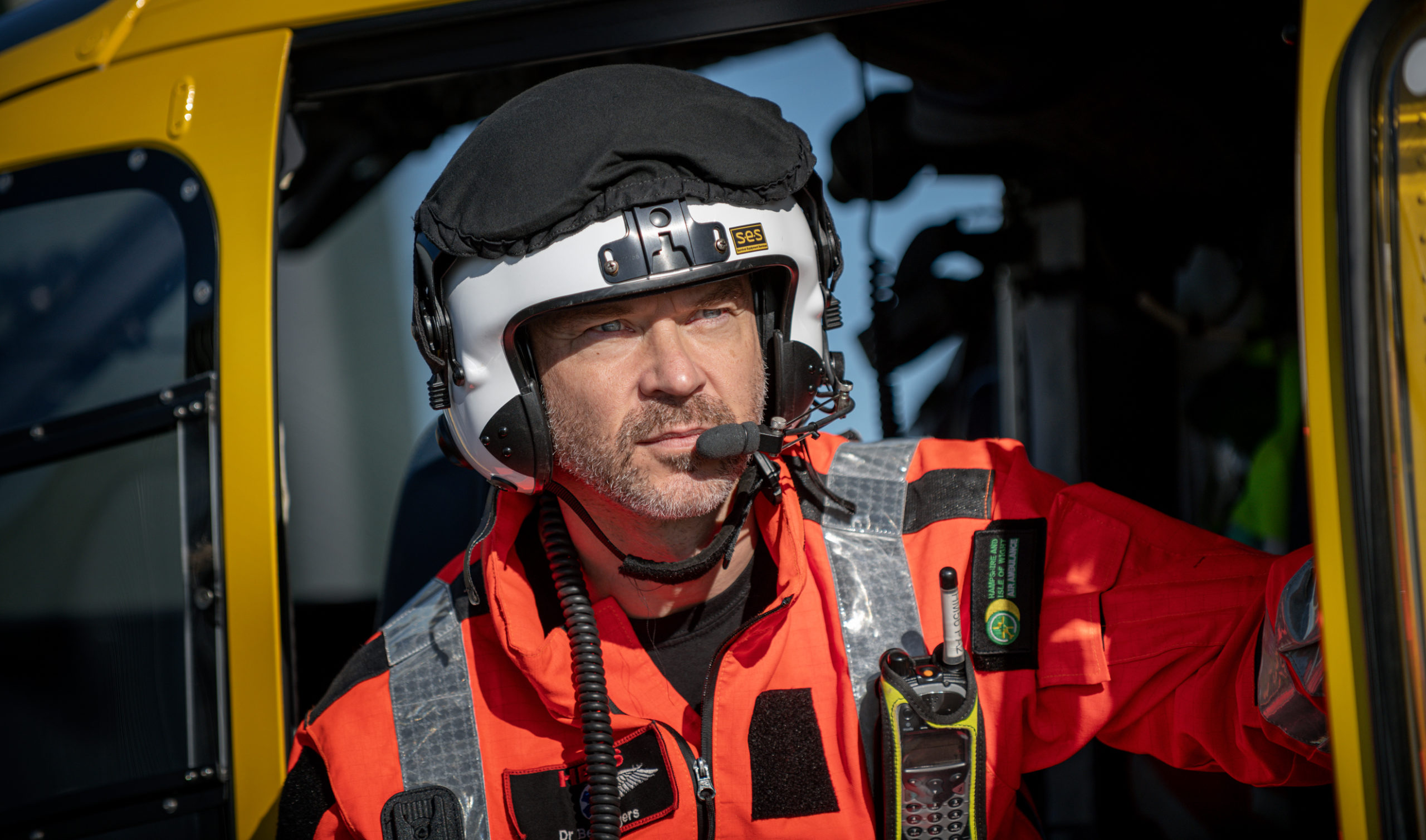 Dr Ben Siggers is wearing a flight suit and flight helmet and is exiting the aircraft.