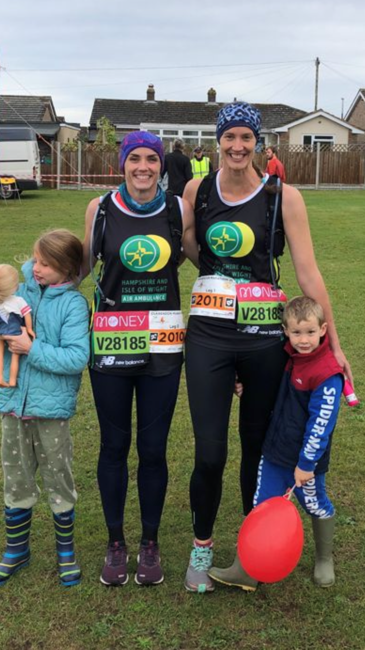 Clare and Kat pictured in their running gear with two young children either side of them