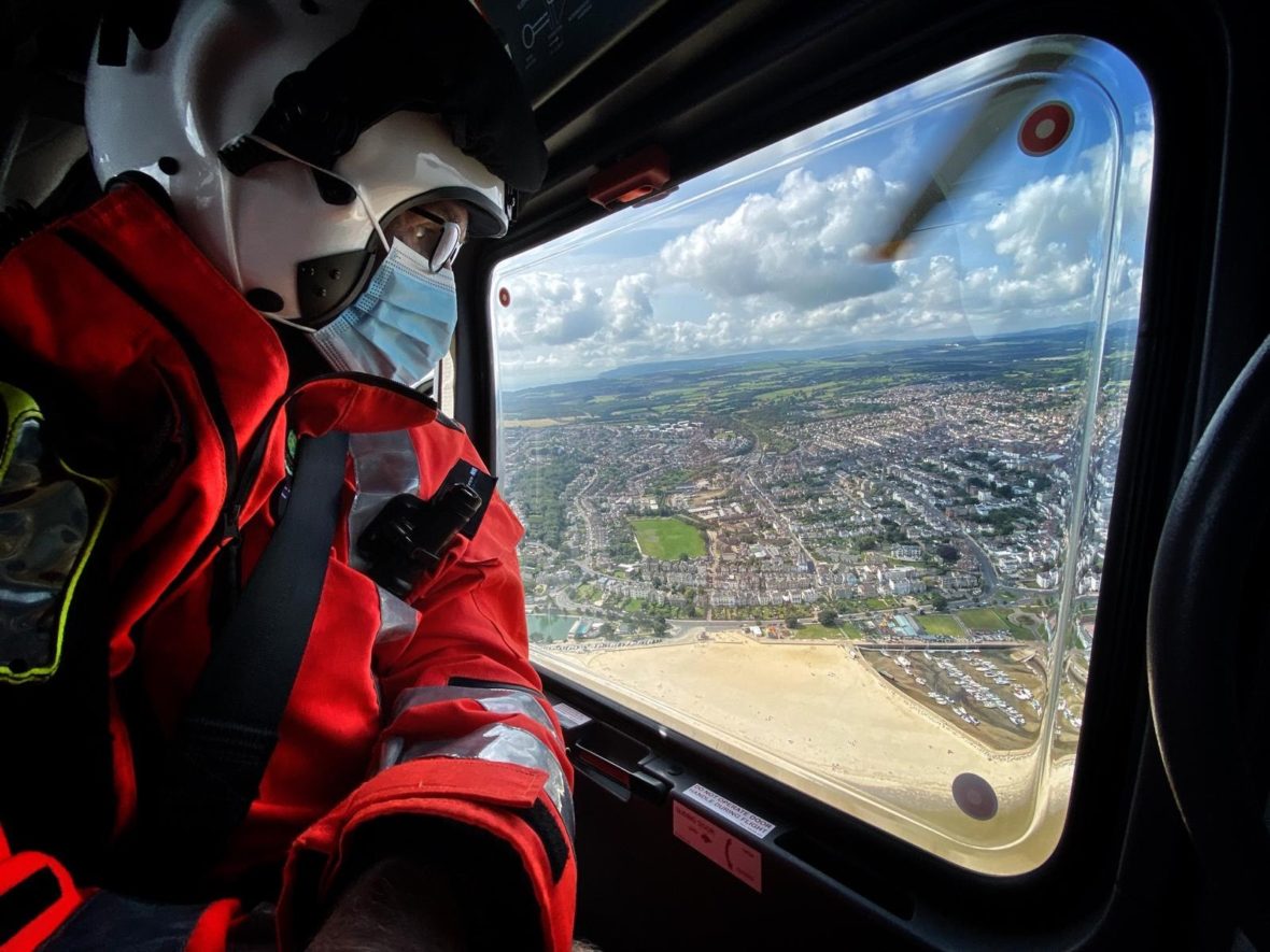 A man looking out of a helicopter window