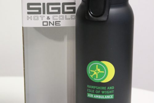 Black SIGG bottle featuring the green and yellow charity logo