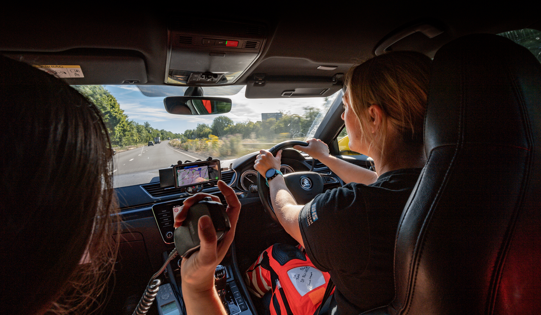 A doctor and paramedic travelling in a response vehicle en route to an emergency