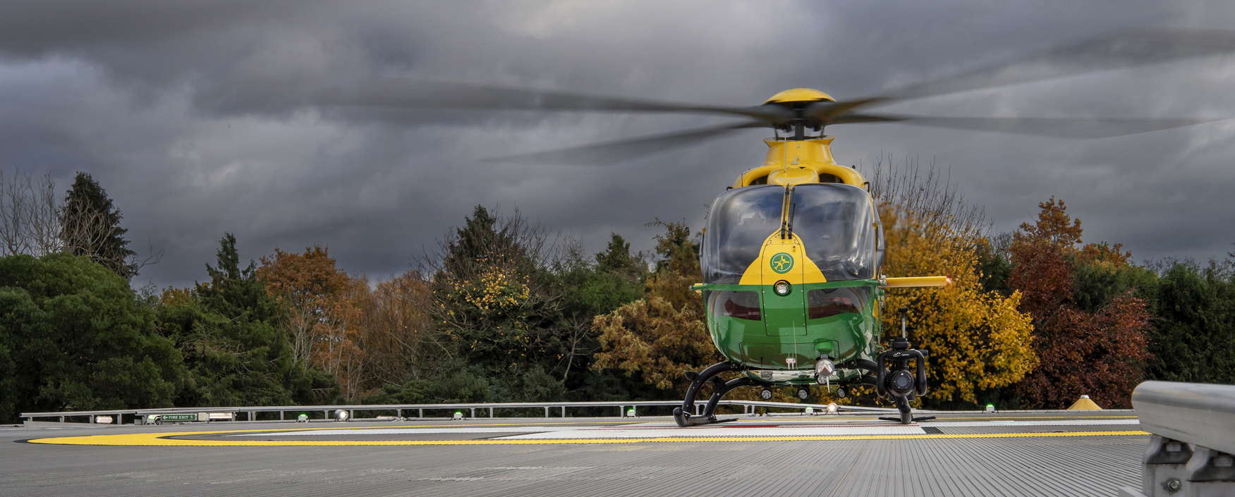 The Air Ambulance Helicopter is on the UHS helipad. The sky is stormy grey.