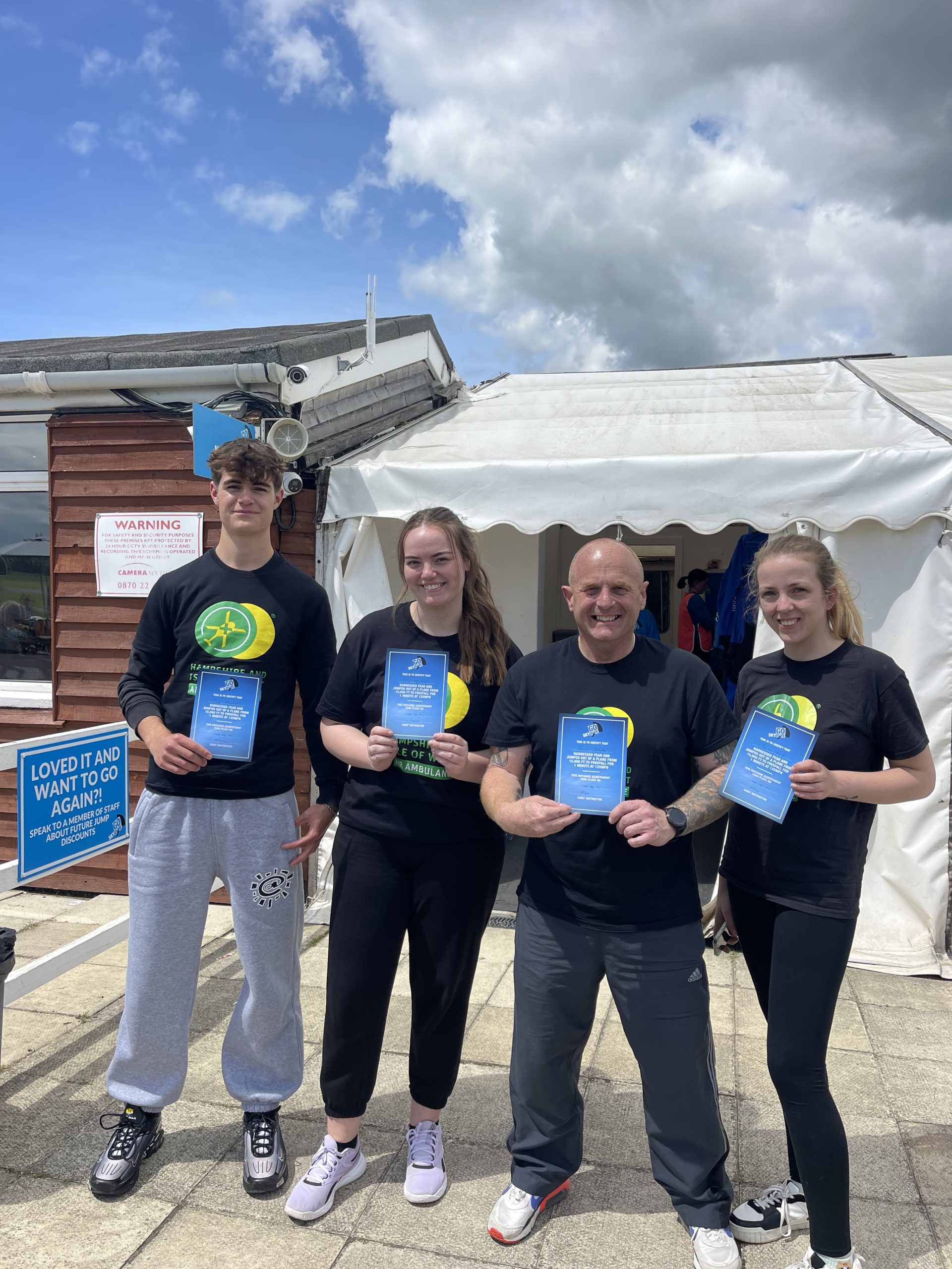 Fundraisers holding there skydiving certificates.