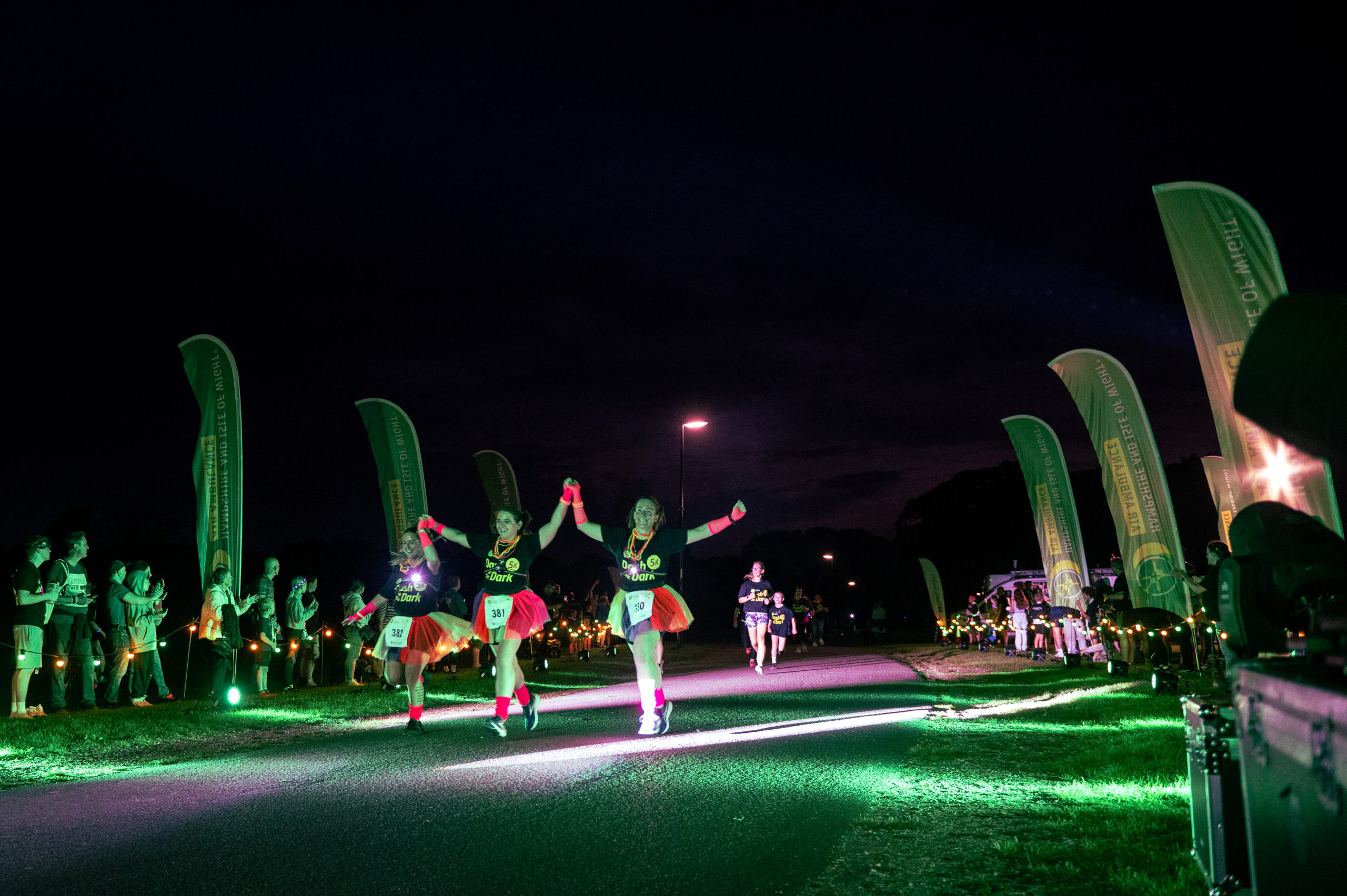 Runners approaching the finish line at Dash in the Dark